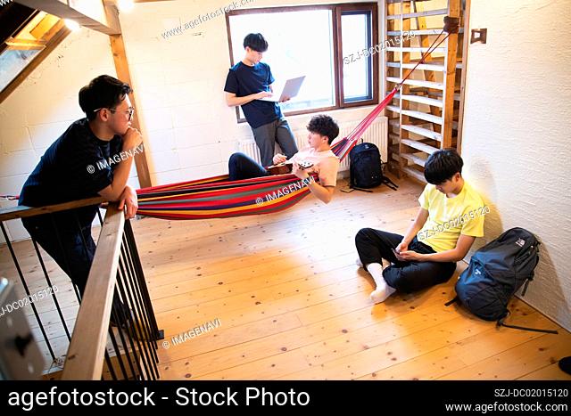 Young people relaxing in vacation rental