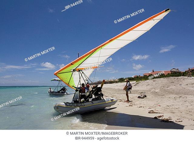 Pilot of a motorised hang glider waiting for passengers on a beach, UL-Trike, Ultra Light airplane with a life boat, Varadero, Cuba, Caribbean, Central America