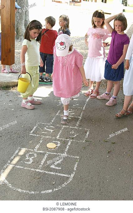HOPSCOTCH GAME Children playing hopscotch in the playground
