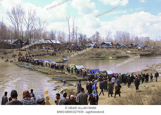People made temporary bridge by joining their wodden boats and walked over it to participate in the Funeral Prayers of Shabir Dar a local Rebel who got killeg...
