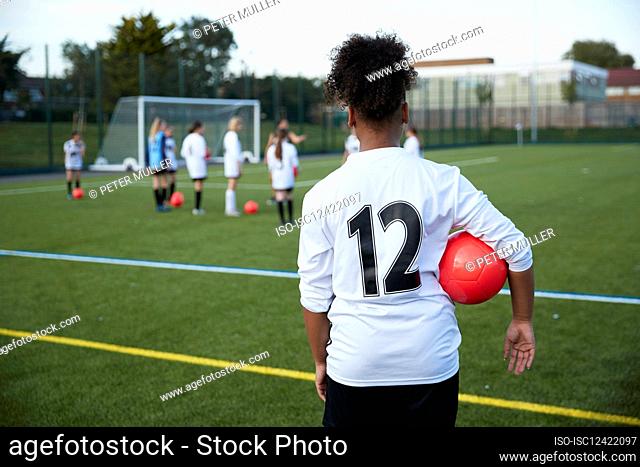 UK, Girls soccer team having training in field