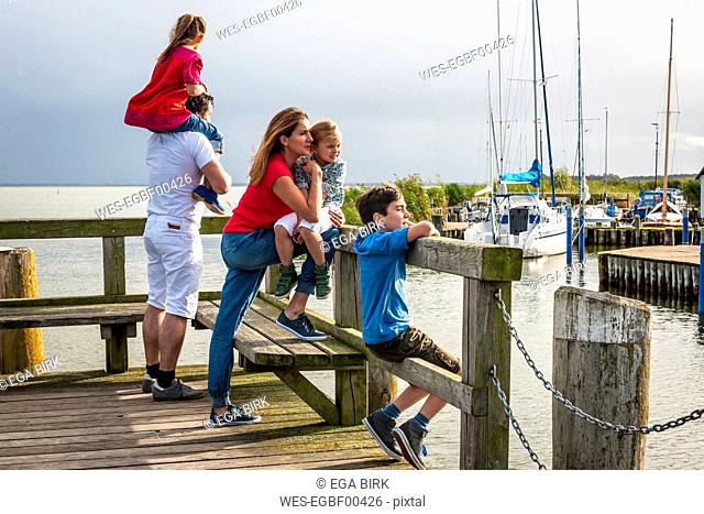 Family standing on a pier looking at view, Ahrenshoop, Mecklenburg-Western Pomerania, Germany
