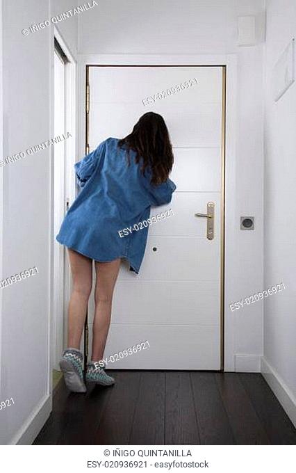 blue jeans shirt woman looking at peephole