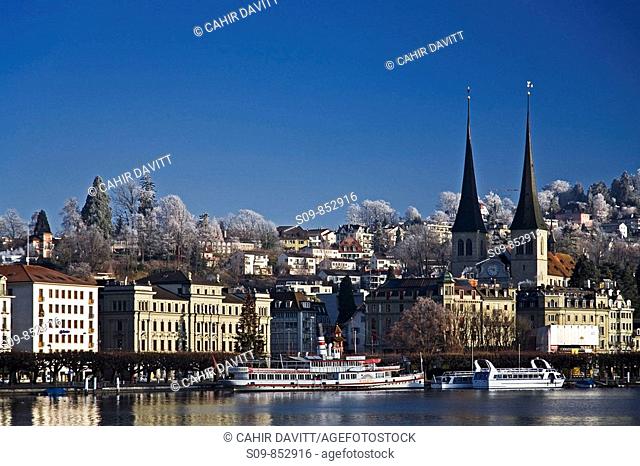 General view of the town of Lucerne Luzern in the Canton of Lucerne, Switzerland with the Reuss River in the foreground and the Hofkirche church in the...