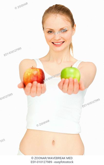 Joyful woman presenting two apples