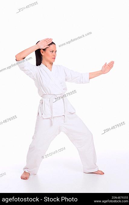Beautiful woman in kimono show martial art exercise on white