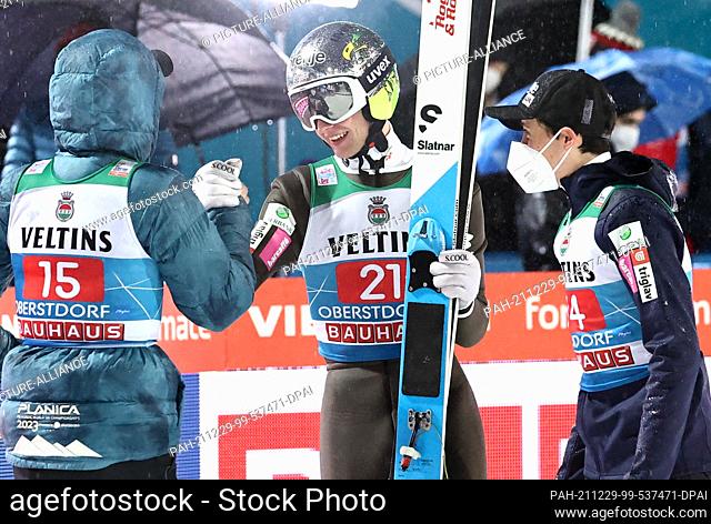 29 December 2021, Bavaria, Oberstdorf: Nordic skiing/ski jumping: World Cup, Four-Hills-Tournament. Lovro Kos (M) from Slovenia cheers after his jump in second...
