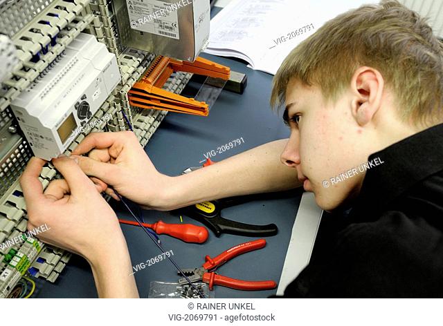 GERMANY : A young trainee in the profession Electronic Engineer working on a specimen - Bonn, Northrhine-, Germany, 24/03/2010
