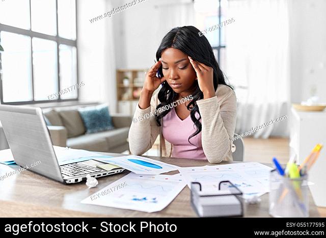stressed woman with papers working at home office