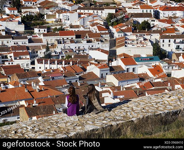 two young women viewing town from Aracena Castle, Aracena, Huelva Province, Spain