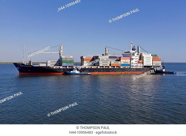 Container ship with two tugs arriving at the Port of Corinto, Nicaragua