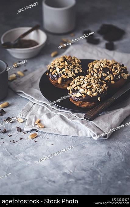 Vegan doughnuts with a caramel filling, chocolate ganache and peanuts