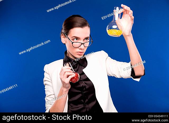 girl with test tubes on a blue background
