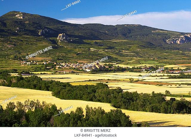 Castle, Castillo de Loarre, and village early in summer with cornfields and landscape, Loarre, Aragon, Spain