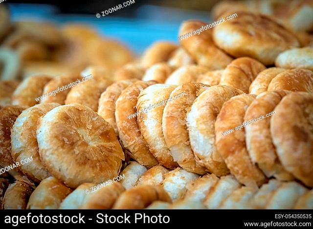 Large plate with delicious small sweet bunsand cakes on sale in bakery in China