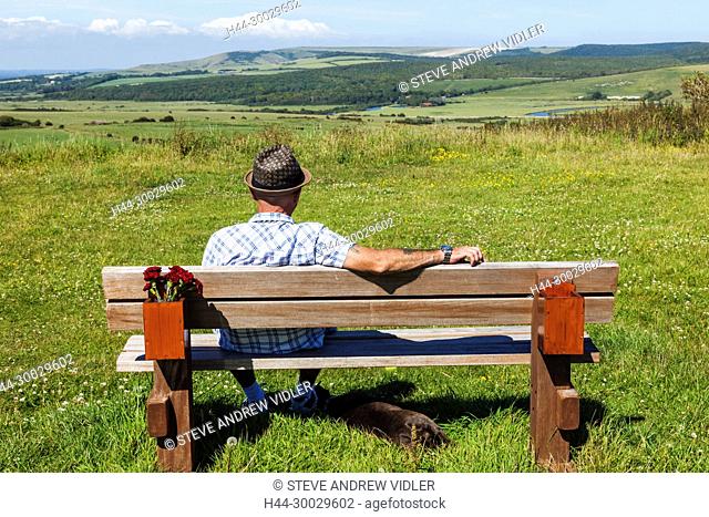 England, East Sussex, Eastbourne, South Downs National Park, Man Sitting on Park Bench