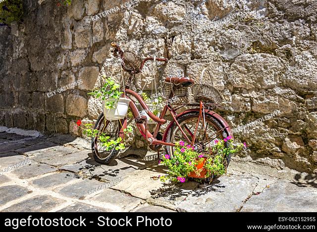 Retro bicycle near old wall in Perast, Montenegro