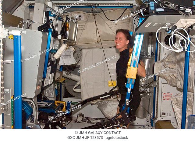 NASA astronaut Shannon Walker, Expedition 24 flight engineer, exercises using the advanced Resistive Exercise Device (aRED) in the Tranquility node of the...
