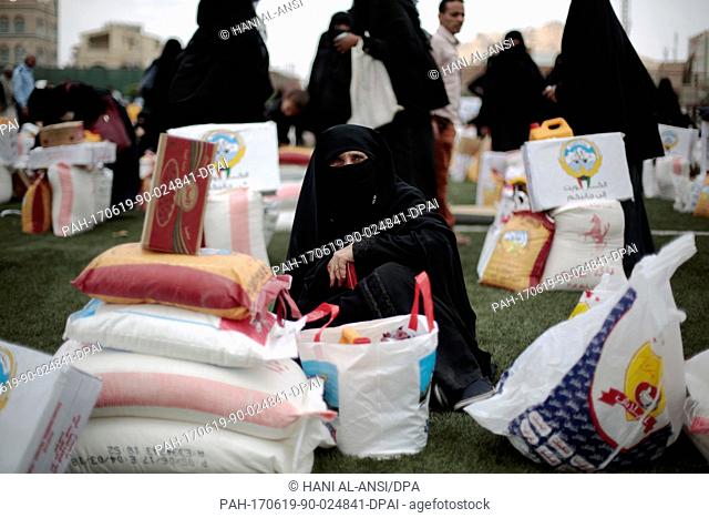 Yemenite women collect an aid donation by the government of Kuwait in Sanaa, Yemen, 19 June 2017. Unabated conflict and rapidly deteriorating conditions across...