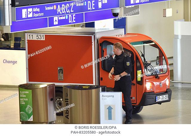 A bomb defuser drives with a special vehicle through the completely evacuated Hall A of Terminal 1 at Frankfurt airport in Frankfurt on the Main,  Germany