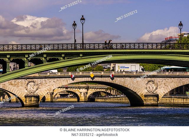 Pedestrians cross Pont d'Arcole, one of the many bridges over the RIver Seine, Paris, France