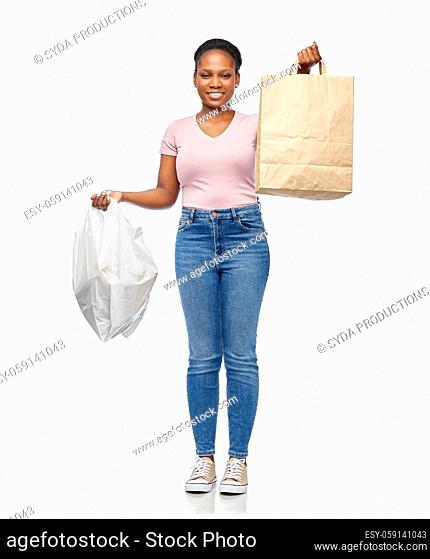 african woman comparing paper and plastic bags