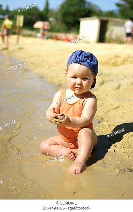 INFANT PLAYING W. WATER OUTDOORS<BR>Child of 11-month-old