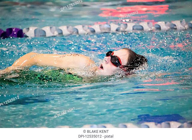 A young woman swimming laps in a lane during a triathalon race; Plano, Texas, United States of America
