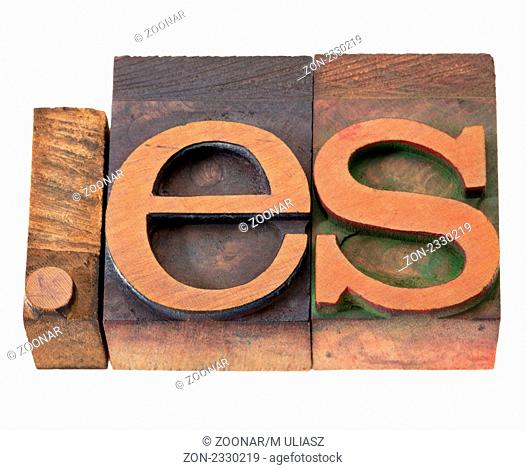 dot es - internet domain for Spain in vintage wooden letterpress printing blocks, stained by color inks, isolated on white
