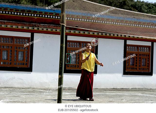 Buddhist monk playing badminton at a monastery