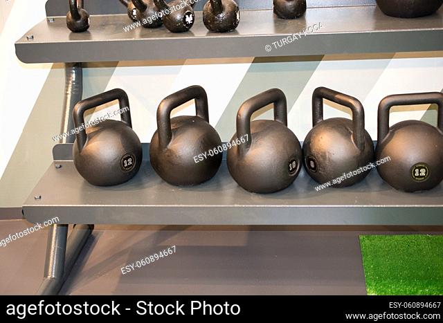 Steel gym kettles on metal stand in the view