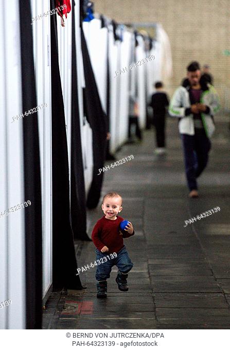 A small child walks past family housing in a hangar at the former Tempelhof Airport in Berlin,  Germany, 09 December 2015