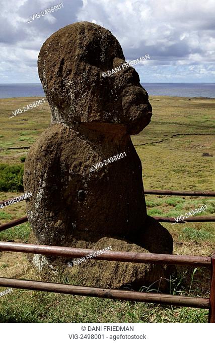 CHILE, RAPA NUI, 17.03.2010, Tukuturi at Rano Raraku is the only kneeling moai and one of the few made of red scoria. Tukuturi is possibly related to the...