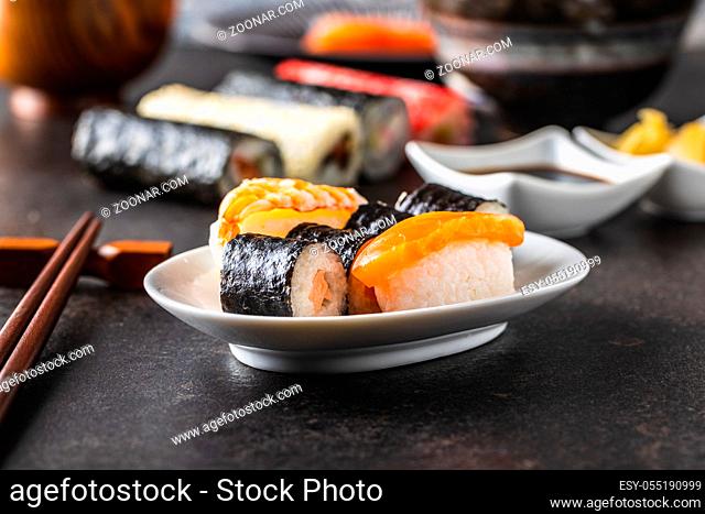 Japanese sushi food. Maki and nigiri roll sushi with salmon, caviar, avocado and tuna