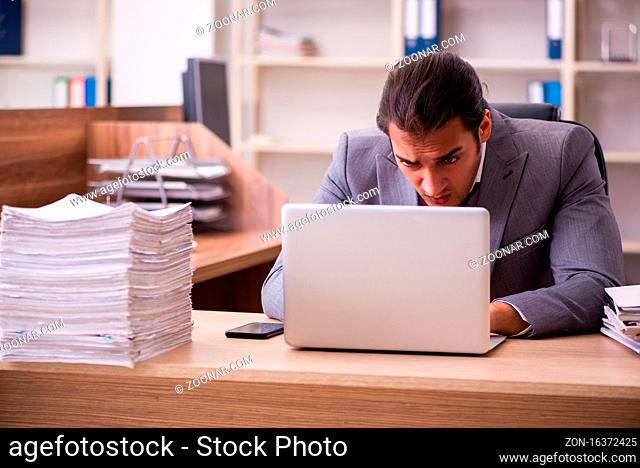 Young employee extremely tired with excessive work