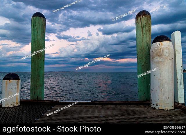 White and green pillars during sunset at the wooden jetty of Cowes, Phillip Island, Australia