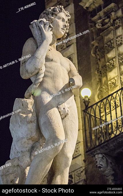 Sculpture of God Amenano symbolizing Amenano River which flows underneath fountain, night view. Amenano Fountain, Piazza Duomo, Metropolitan City of Catania