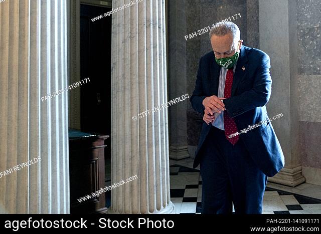 United States Senate Majority Leader Chuck Schumer (Democrat of New York) looks at his watch while walking to the Senate Chamber at the U.S