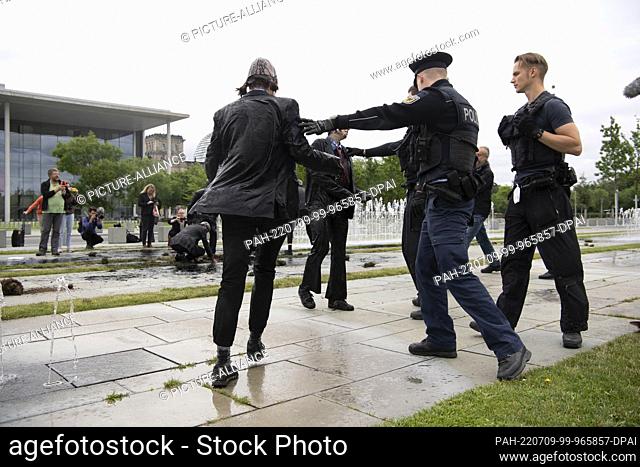 09 July 2022, Berlin: Police officers stand in front of the Chancellery at climate protection activists of the group ""Last Generation""