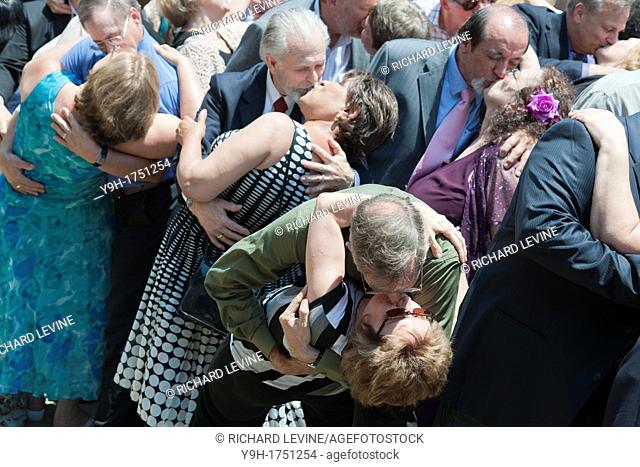 Couples re-enact the famous V-Day kiss outside Madison Square Garden for a group photograph celebrating the 30th anniversary of the Rev Sun Myung Moon's mass...
