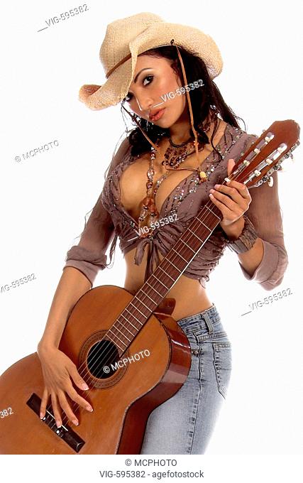Super sexy rodeo cowgirl in torn jeans, boots and cowboyhat with a nylon string acoustic guitar - 18/12/2007