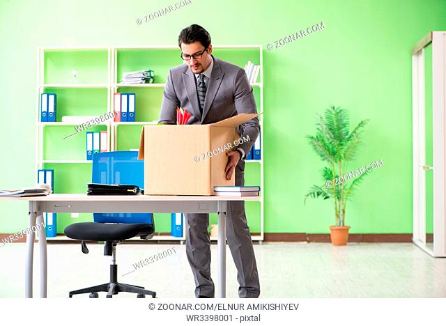 Male employee collecting his stuff after redundancy