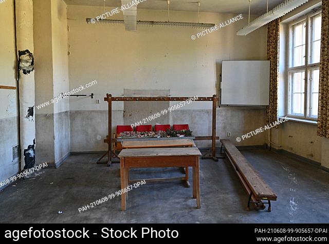 03 June 2021, Brandenburg, Templin: Benches and a clothes rack stand in an old classroom in the ""Joachimsthalsches Gymnasium building ensemble""