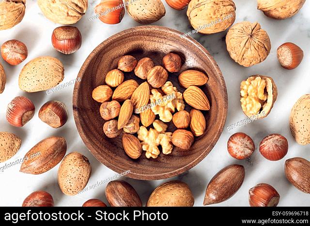 Nuts Mixed in a wooden plate.Assortment, Walnuts, Pecan, Almonds, Hazelnuts. Healthy appetizer