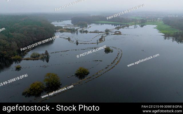 15 December 2023, Lower Saxony, Deutsch Evern: The Ilmenau has flooded adjacent meadows (photo taken with a drone). After persistent rainfall and thawing...