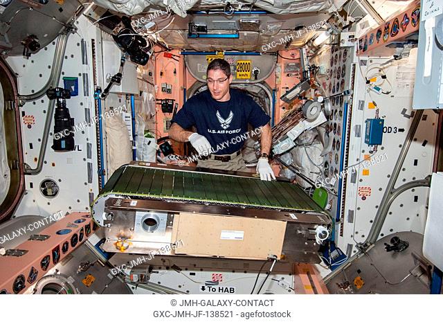NASA astronaut Mike Hopkins, Expedition 38 flight engineer, works on the COLBERT treadmill in the Unity node of the International Space Station