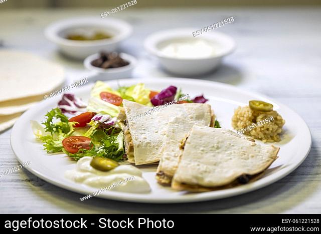 chicken quesadilla with rice, beans, salad, chalapenos and salsa