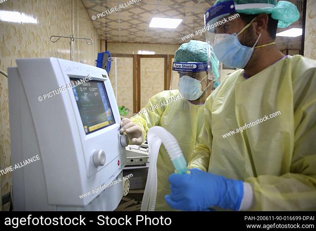11 June 2020, Syria, Idlib: Doctors wearing full protective gear check medical equipment and respirators at the first specialized hospital for coronavirus cases...