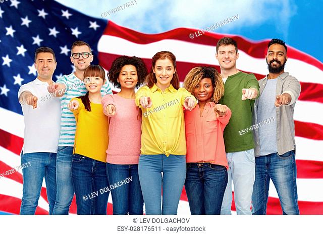 diversity, choice, ethnicity and people concept - international group of happy smiling men and women pointing finger on you over american flag background