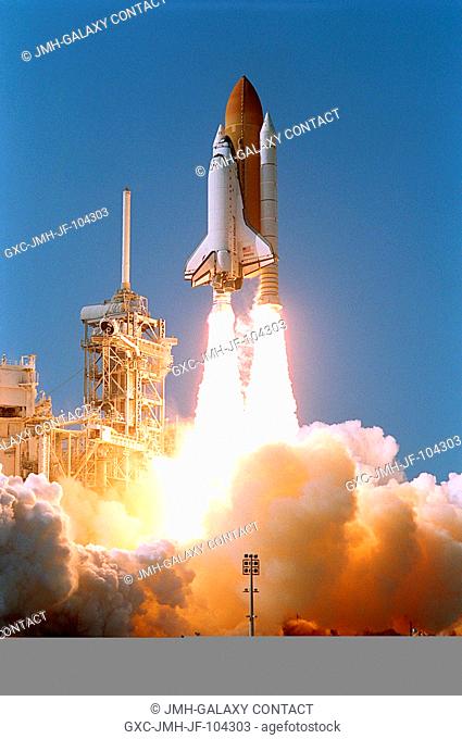 KENNEDY SPACE CENTER, FLA. - Space Shuttle Atlantis leaps from the steam and smoke billowing across Launch Pad 39B after an on-time liftoff of 3:46 p